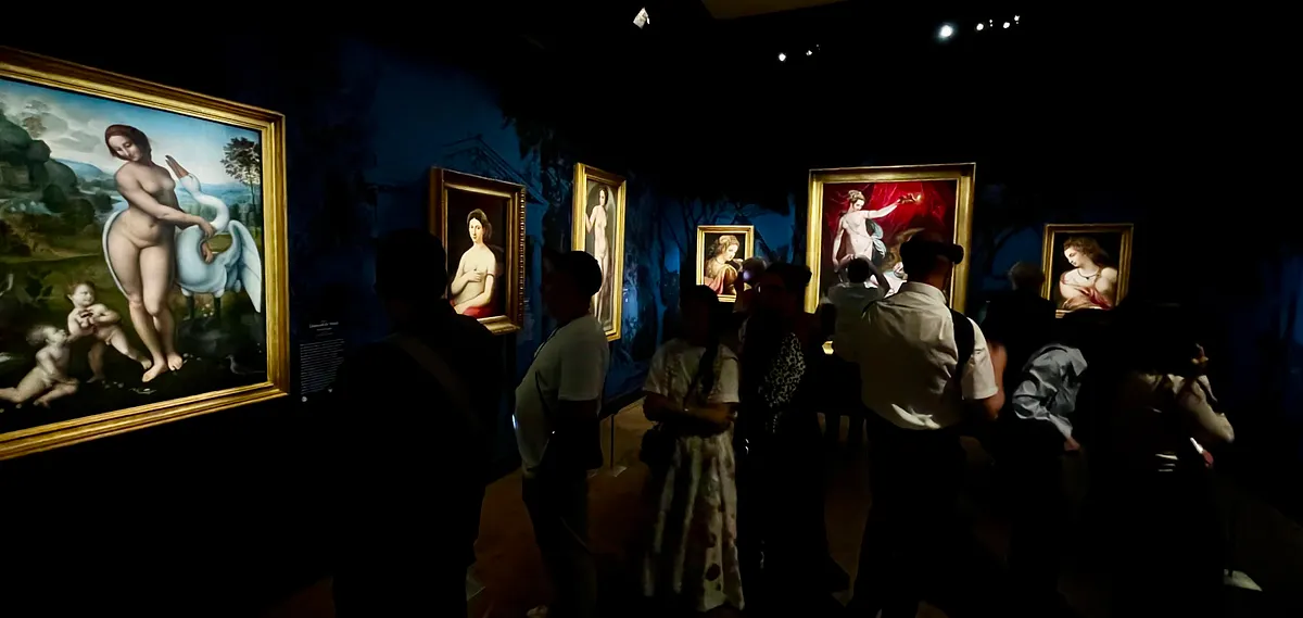 Visitors in the dimly lit rooms of the Borghese exhibition