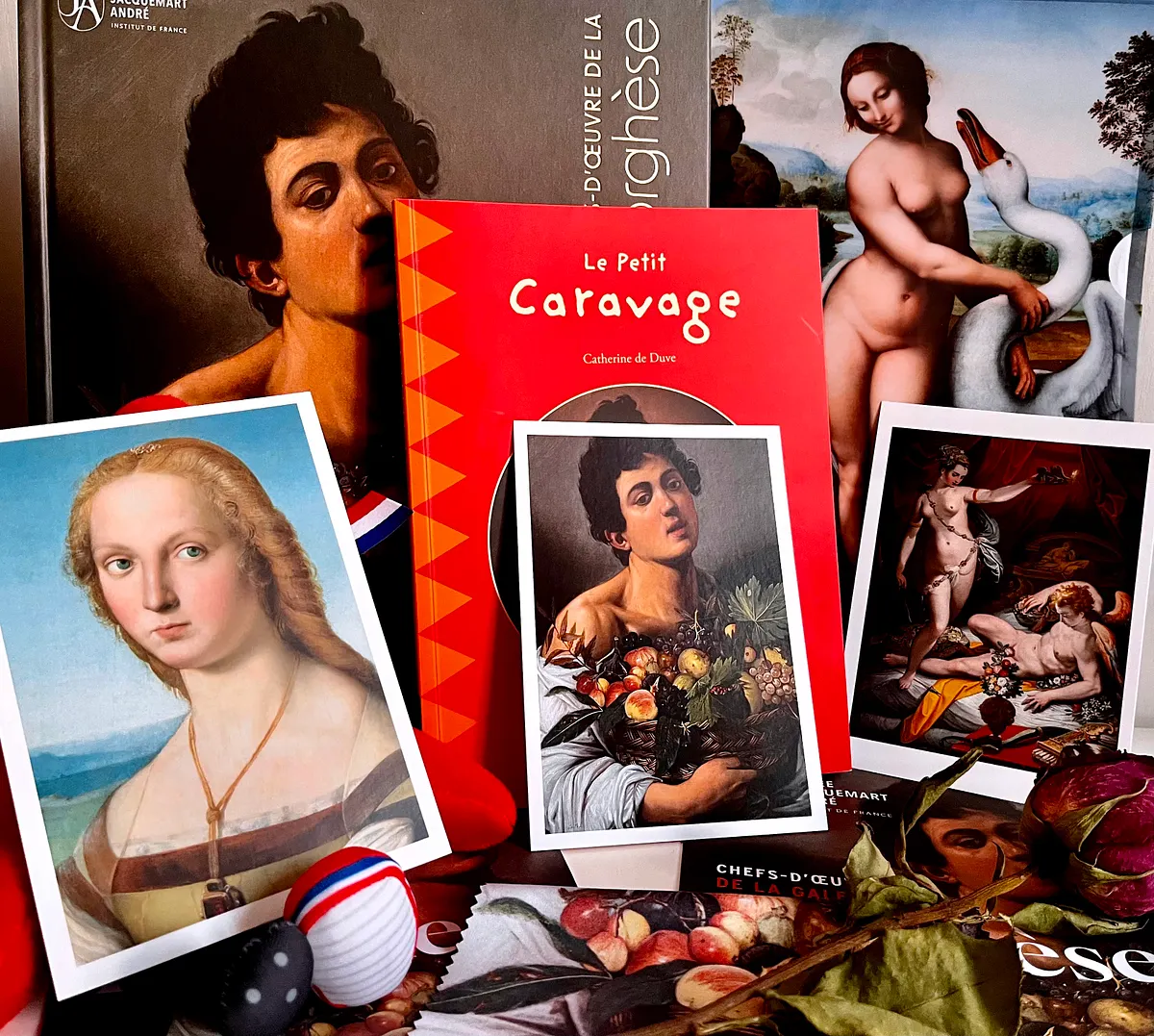 Books and postcards from the exhibition shop, including Le Petit Caravage